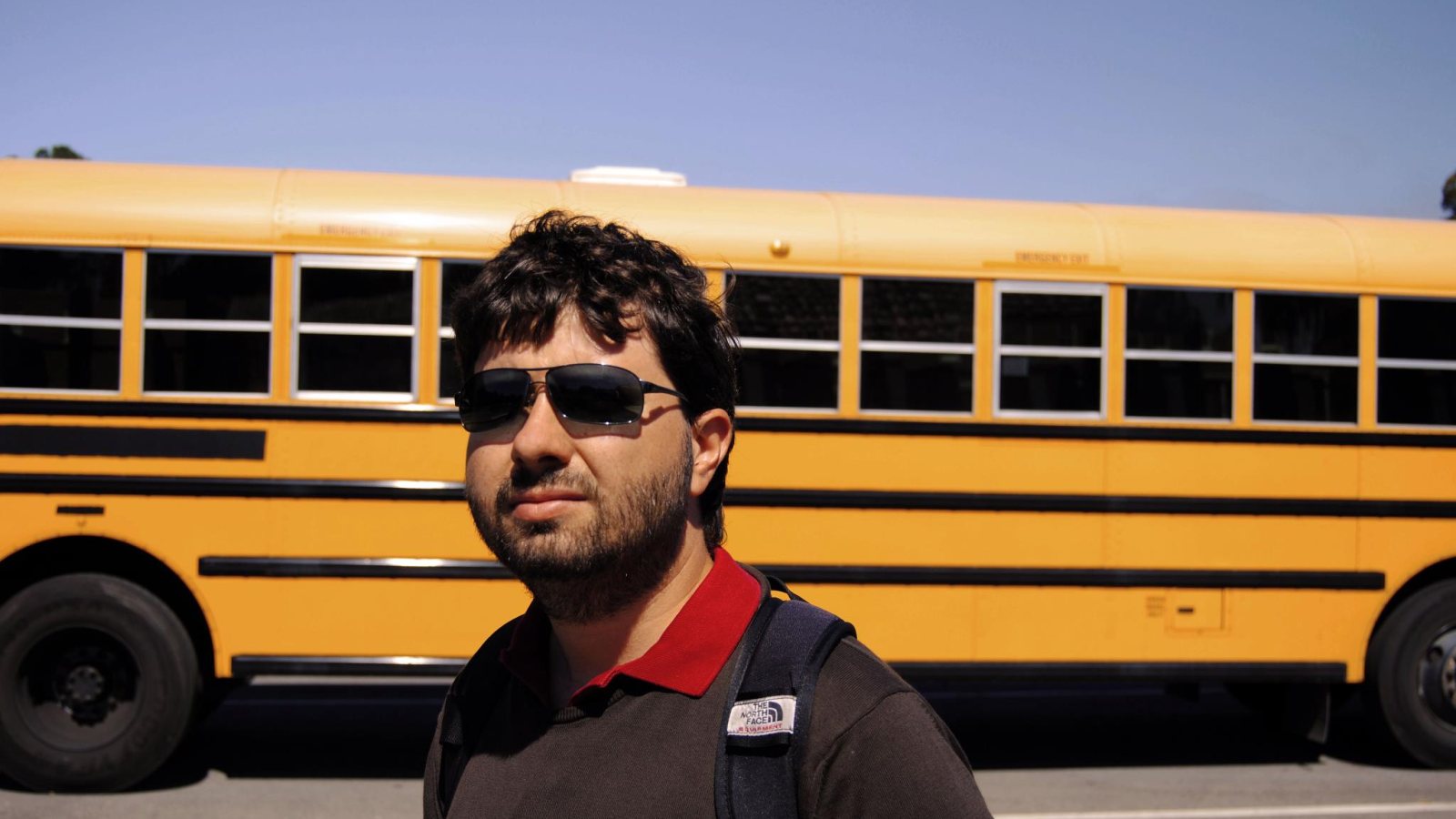 Giuseppe Tumino in front of a yellow school bus